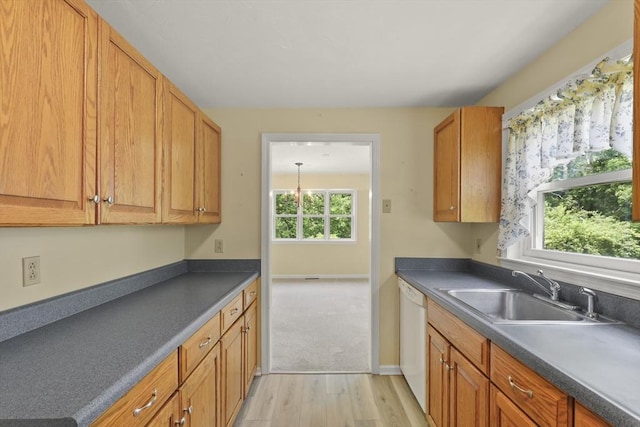 18 Harbor Hill Dr Unit 18, Bourne, MA 02532 - kitchen with white dishwasher, light wood-style floors, dark countertops, and brown cabinetry