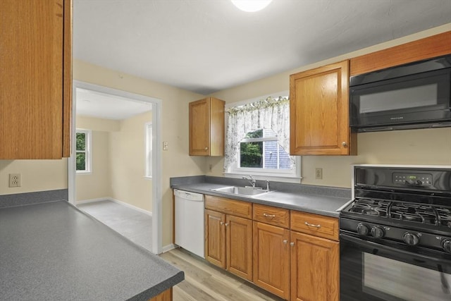 18 Harbor Hill Dr Unit 18, Bourne, MA 02532 - kitchen with black appliances, dark countertops, and brown cabinetry