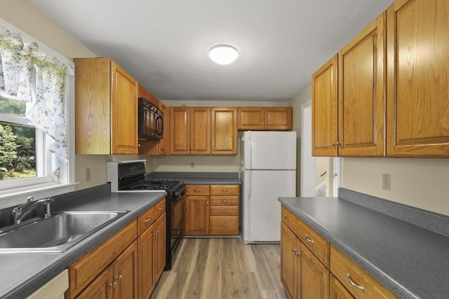 18 Harbor Hill Dr Unit 18, Bourne, MA 02532 - kitchen featuring black appliances, light wood-type flooring, dark countertops, and brown cabinets