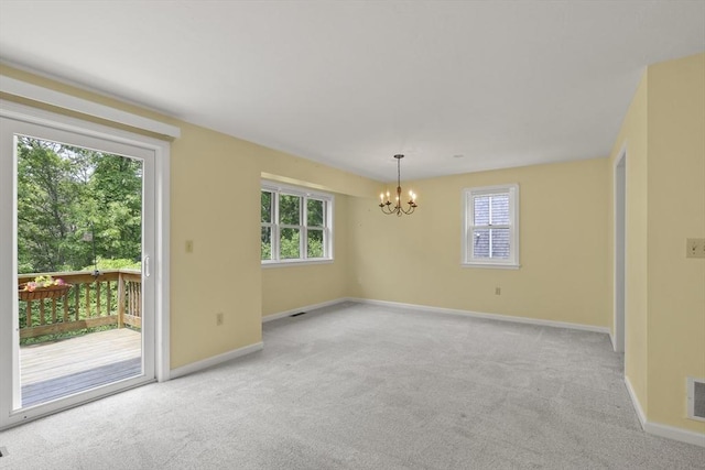 18 Harbor Hill Dr Unit 18, Bourne, MA 02532 - empty room featuring a chandelier, light colored carpet, and healthy amount of natural light