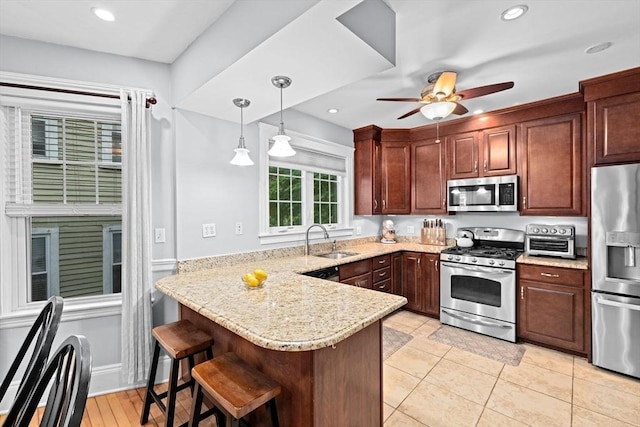26 N Munroe Ter Unit 1, Boston, MA 02122 - kitchen featuring appliances with stainless steel finishes, a sink, a peninsula, a breakfast bar, and a ceiling fan