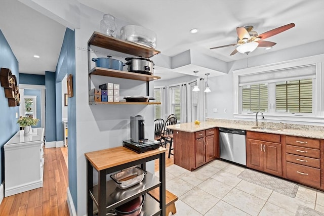 26 N Munroe Ter Unit 1, Boston, MA 02122 - kitchen featuring dishwasher, a sink, a ceiling fan, brown cabinetry, and light stone countertops