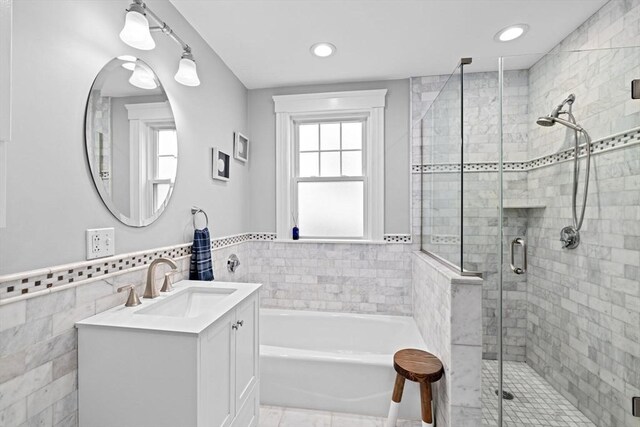 26 N Munroe Ter Unit 1, Boston, MA 02122 - bathroom with a bath, vanity, a shower stall, tile walls, and a wainscoted wall