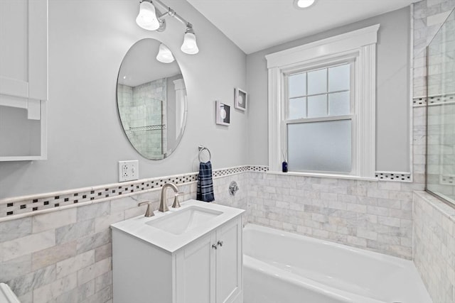 26 N Munroe Ter Unit 1, Boston, MA 02122 - bathroom featuring tile walls, a bath, vanity, and a wainscoted wall