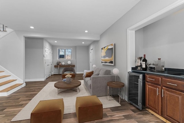 living room with bar area, beverage cooler, and dark wood-type flooring