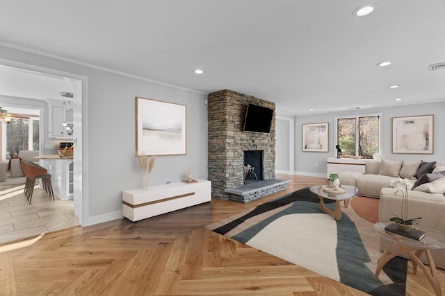 living room featuring a fireplace, light parquet floors, and ornamental molding