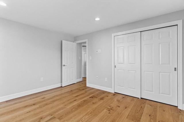 unfurnished bedroom with light hardwood / wood-style floors and a closet