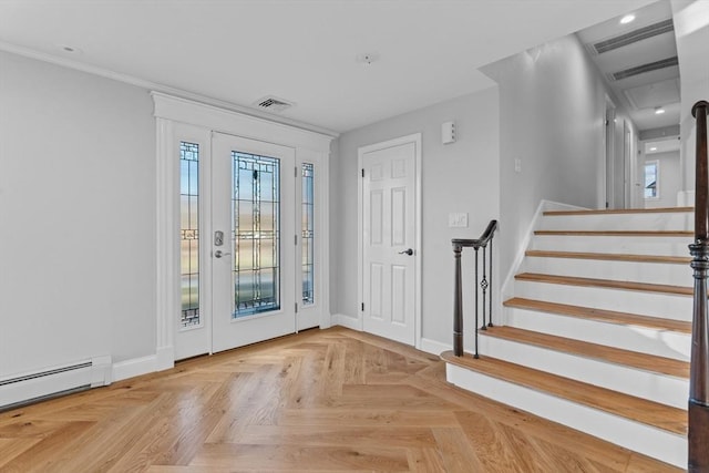 foyer with a baseboard radiator, light parquet floors, and ornamental molding