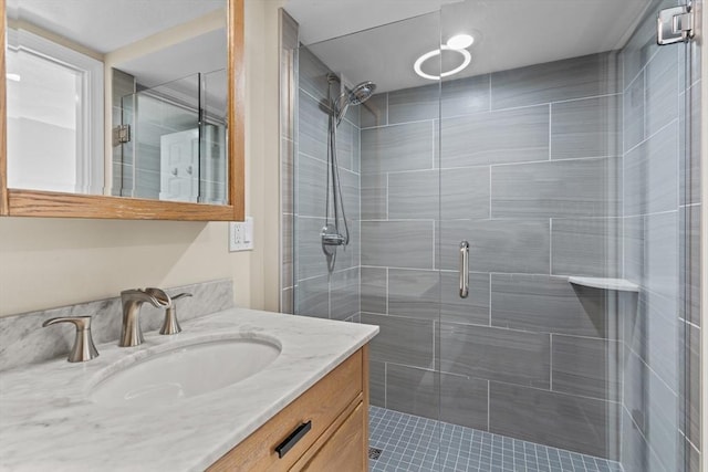 bathroom with a shower with door and vanity