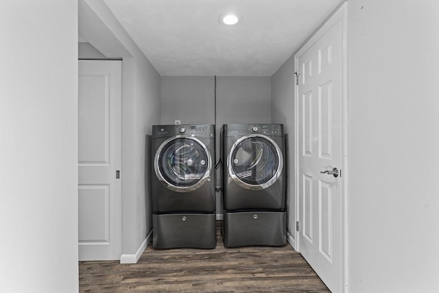 washroom featuring dark wood-type flooring and washer and dryer