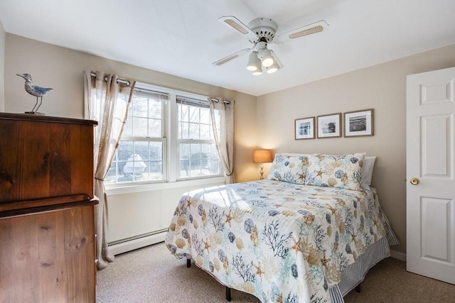 carpeted bedroom with a baseboard radiator and ceiling fan