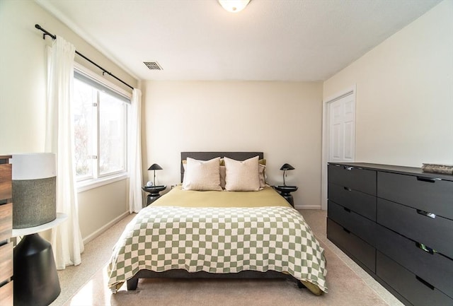 bedroom featuring light colored carpet, visible vents, and baseboards