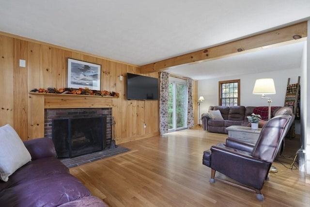 62 Teakettle Ln, Duxbury, MA 02332 - living room featuring wood finished floors, a brick fireplace, wooden walls, and beam ceiling