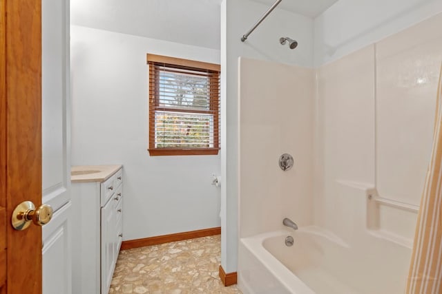 bathroom featuring washtub / shower combination and vanity