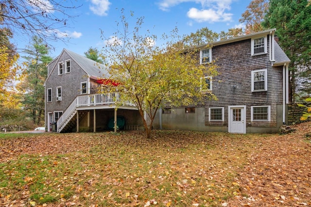 rear view of property featuring a wooden deck