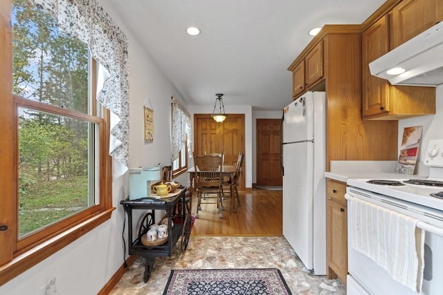 62 Teakettle Ln, Duxbury, MA 02332 - kitchen with white appliances, under cabinet range hood, brown cabinets, light countertops, and recessed lighting