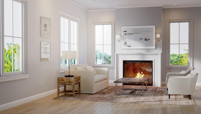 living area featuring light hardwood / wood-style floors, ornamental molding, and a healthy amount of sunlight