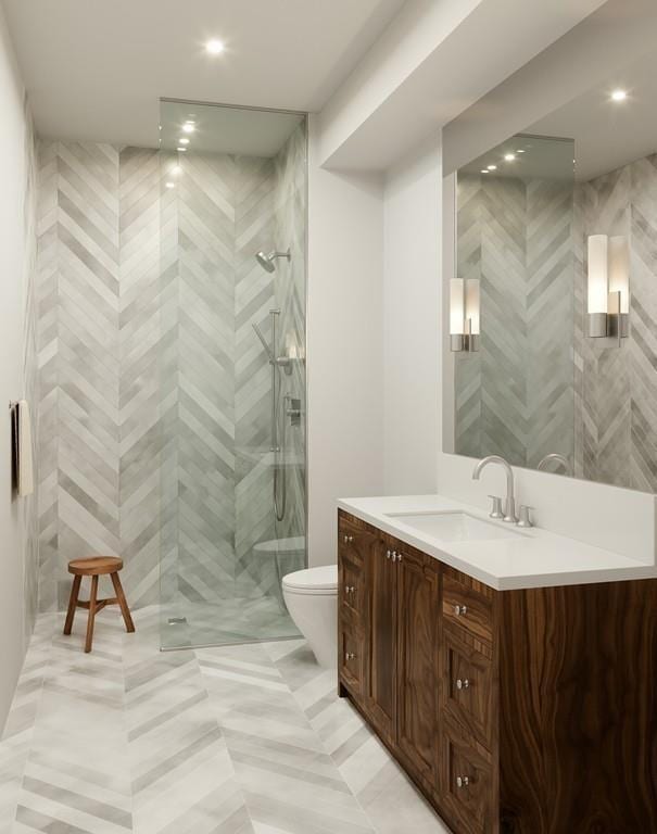 bathroom with tile floors, walk in shower, toilet, and vanity