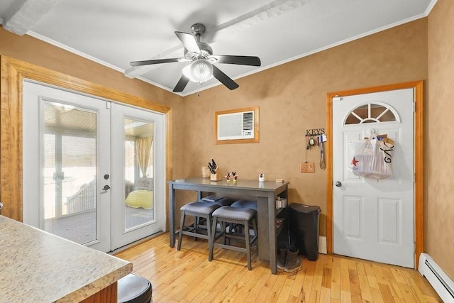 dining space with light wood-style flooring, a baseboard heating unit, a ceiling fan, french doors, and ornamental molding