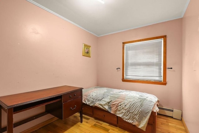 bedroom with light wood-style floors, baseboards, ornamental molding, and baseboard heating