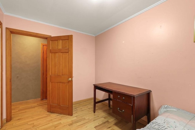 bedroom featuring light wood-style floors and ornamental molding