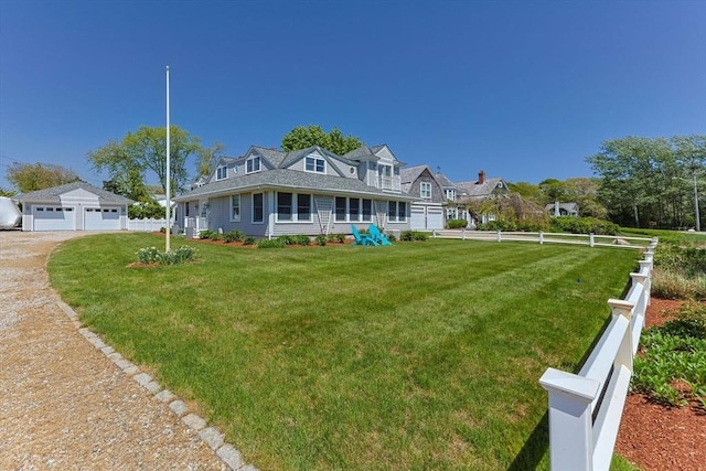 view of front of house featuring a detached garage and an outdoor structure