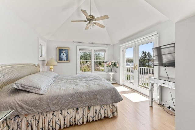 bedroom featuring access to exterior, french doors, wood finished floors, ceiling fan, and high vaulted ceiling
