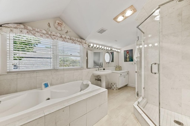 full bathroom featuring a shower stall, a garden tub, and lofted ceiling