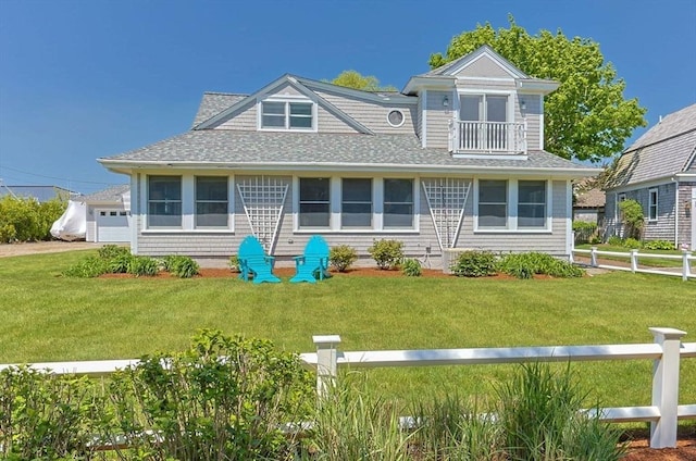 view of front of house with a shingled roof and a balcony