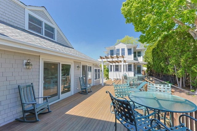 deck with a pergola and outdoor dining area