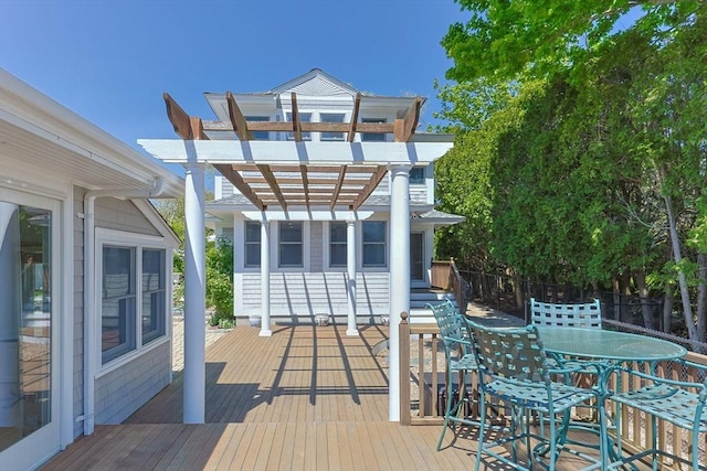 wooden terrace with a pergola and outdoor dining area