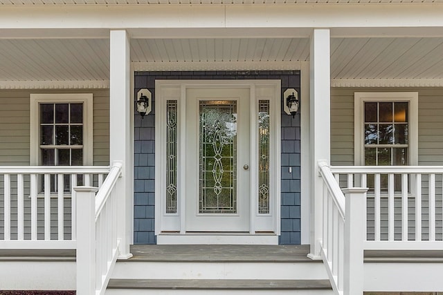 view of exterior entry featuring a porch