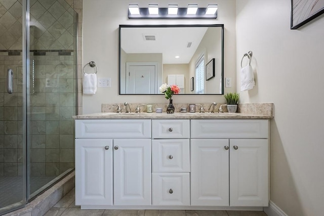 bathroom with tile patterned flooring, vanity, and an enclosed shower