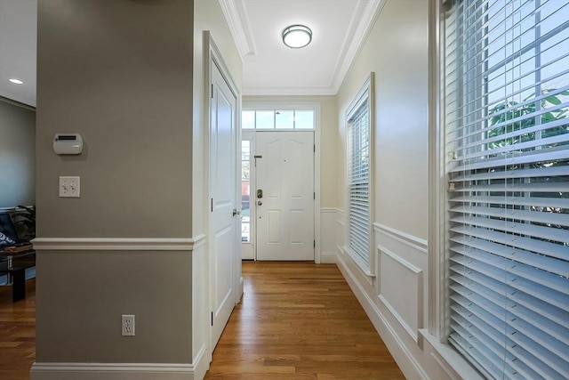 doorway featuring wood-type flooring and ornamental molding