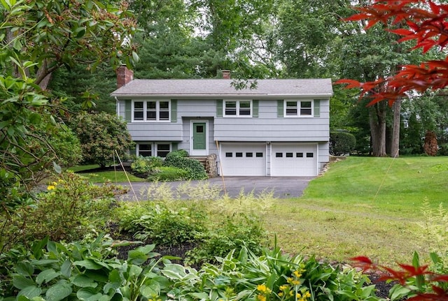 46 Plum St, Hamilton, MA 01982 - bi-level home featuring driveway, a garage, a chimney, and a front lawn