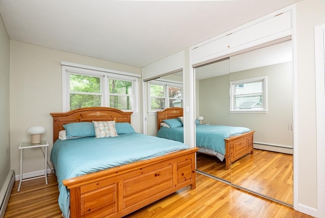 46 Plum St, Hamilton, MA 01982 - bedroom with a baseboard radiator, multiple closets, and light wood-style floors