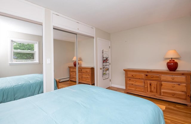 46 Plum St, Hamilton, MA 01982 - bedroom featuring a baseboard heating unit and wood finished floors