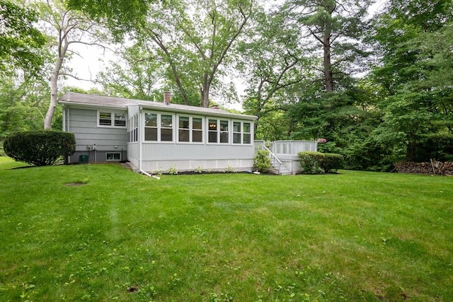 46 Plum St, Hamilton, MA 01982 - rear view of house featuring a sunroom and a lawn