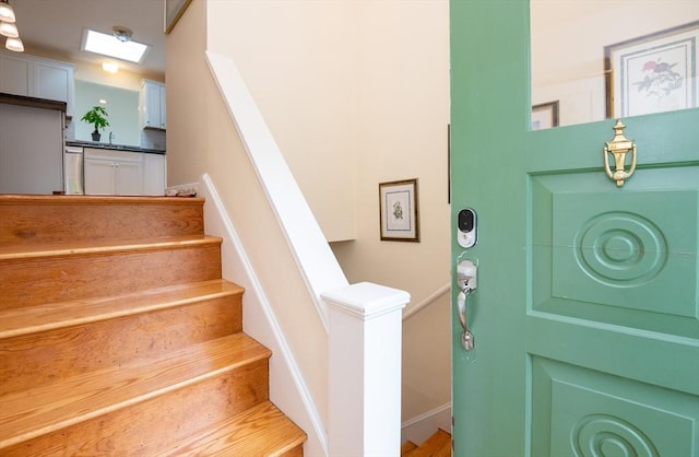 46 Plum St, Hamilton, MA 01982 - staircase with a skylight and baseboards