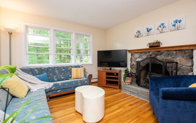 46 Plum St, Hamilton, MA 01982 - living room featuring a baseboard heating unit, wood finished floors, and a stone fireplace