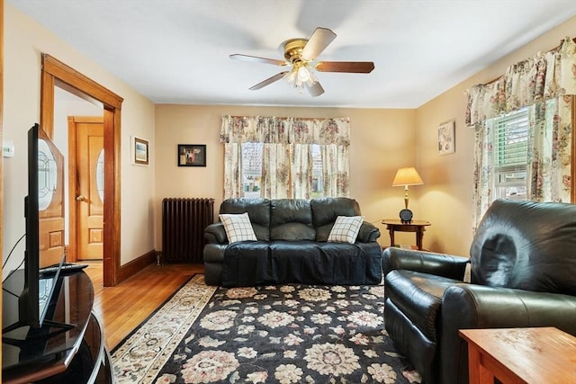 57 Taft St, Medford, MA 02155 - living room with radiator, light wood-type flooring, a ceiling fan, and baseboards