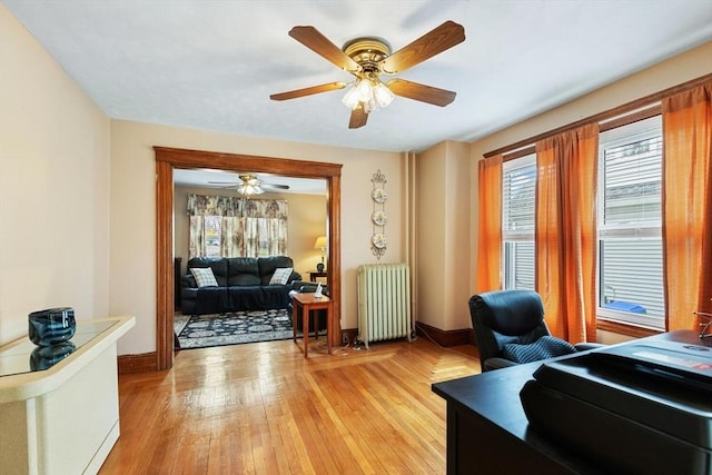 57 Taft St, Medford, MA 02155 - home office featuring radiator heating unit, ceiling fan, light wood-type flooring, and baseboards