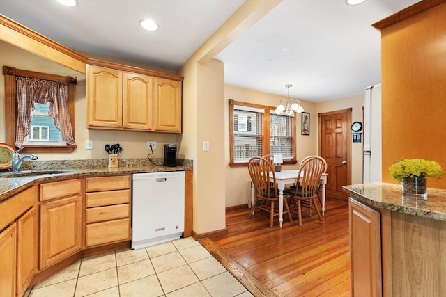 57 Taft St, Medford, MA 02155 - kitchen featuring white dishwasher, a sink, a chandelier, stone countertops, and plenty of natural light