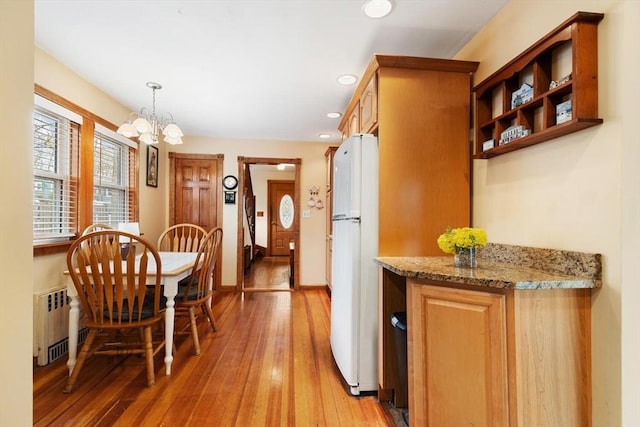 57 Taft St, Medford, MA 02155 - dining area with radiator heating unit, a chandelier, light wood-style floors, and recessed lighting
