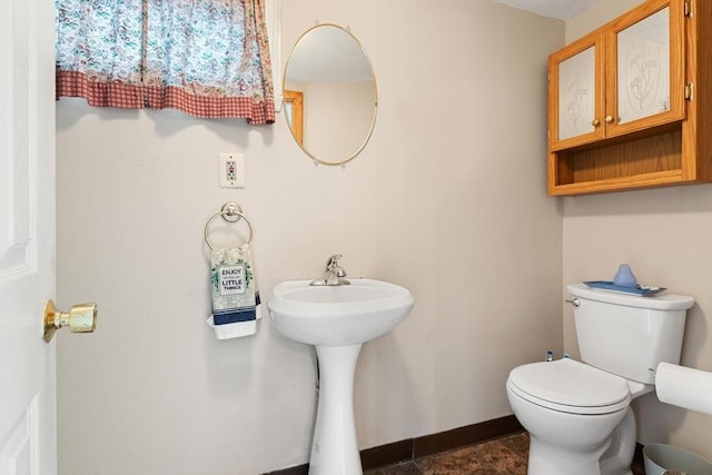 57 Taft St, Medford, MA 02155 - bathroom featuring toilet, baseboards, and a sink