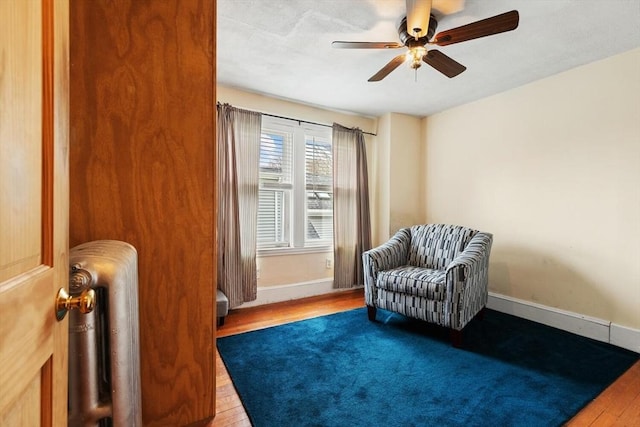 57 Taft St, Medford, MA 02155 - living area with wood finished floors, a ceiling fan, baseboards, and radiator heating unit