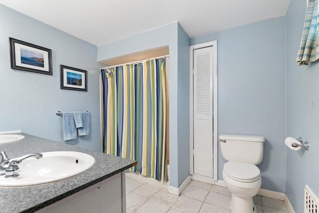 57 Taft St, Medford, MA 02155 - bathroom featuring double vanity, a closet, tile patterned floors, toilet, and baseboards