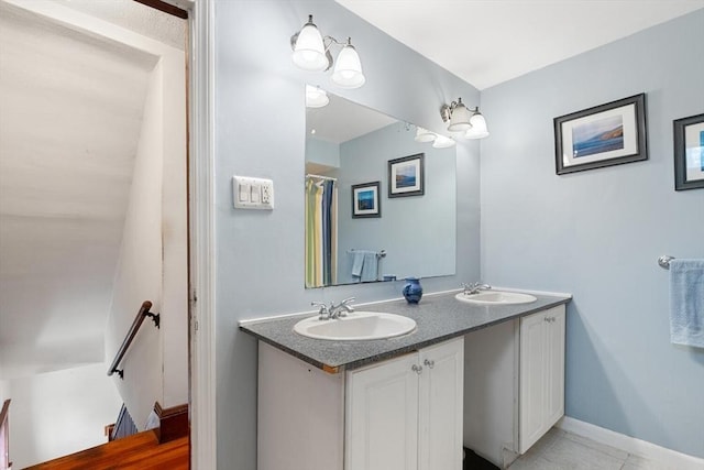 57 Taft St, Medford, MA 02155 - full bathroom with double vanity, baseboards, and tile patterned flooring