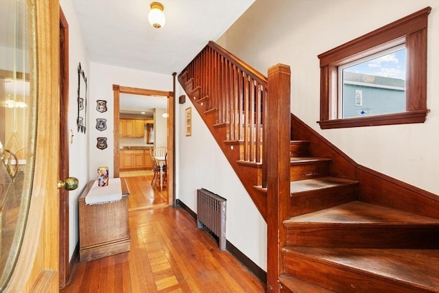 57 Taft St, Medford, MA 02155 - staircase featuring radiator heating unit and hardwood / wood-style floors