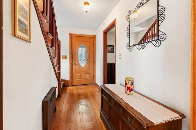 57 Taft St, Medford, MA 02155 - doorway featuring radiator, hardwood / wood-style floors, and stairs